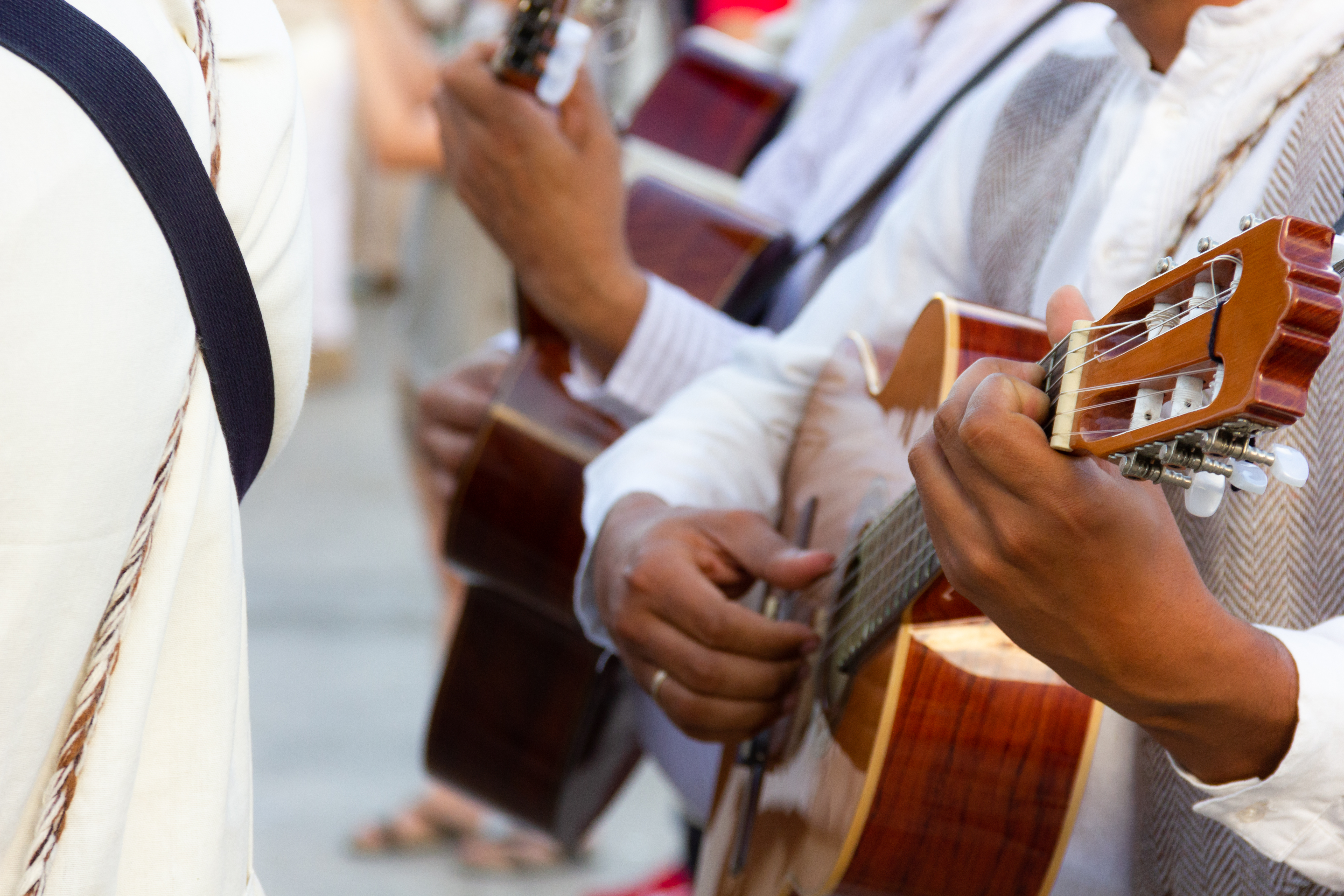 Closeup on guitar players wearing local costumes in Las Palmas
